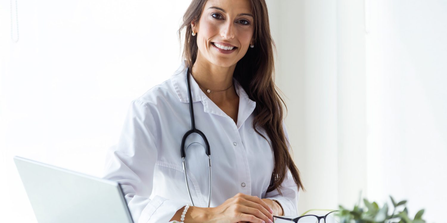 Portrait of beautiful young female doctor looking at camera in the office.